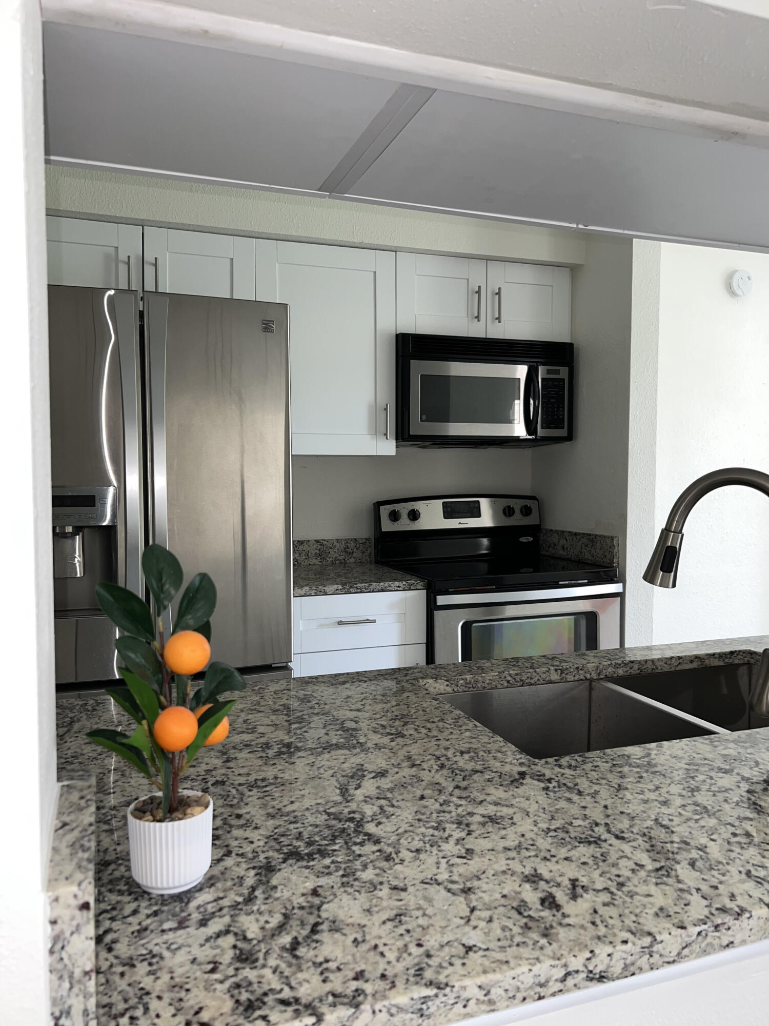 899 Riverside Drive, Unit 620 Coral Springs, FL 33071 - Photo 7 of 46 a kitchen with a refrigerator and a sink