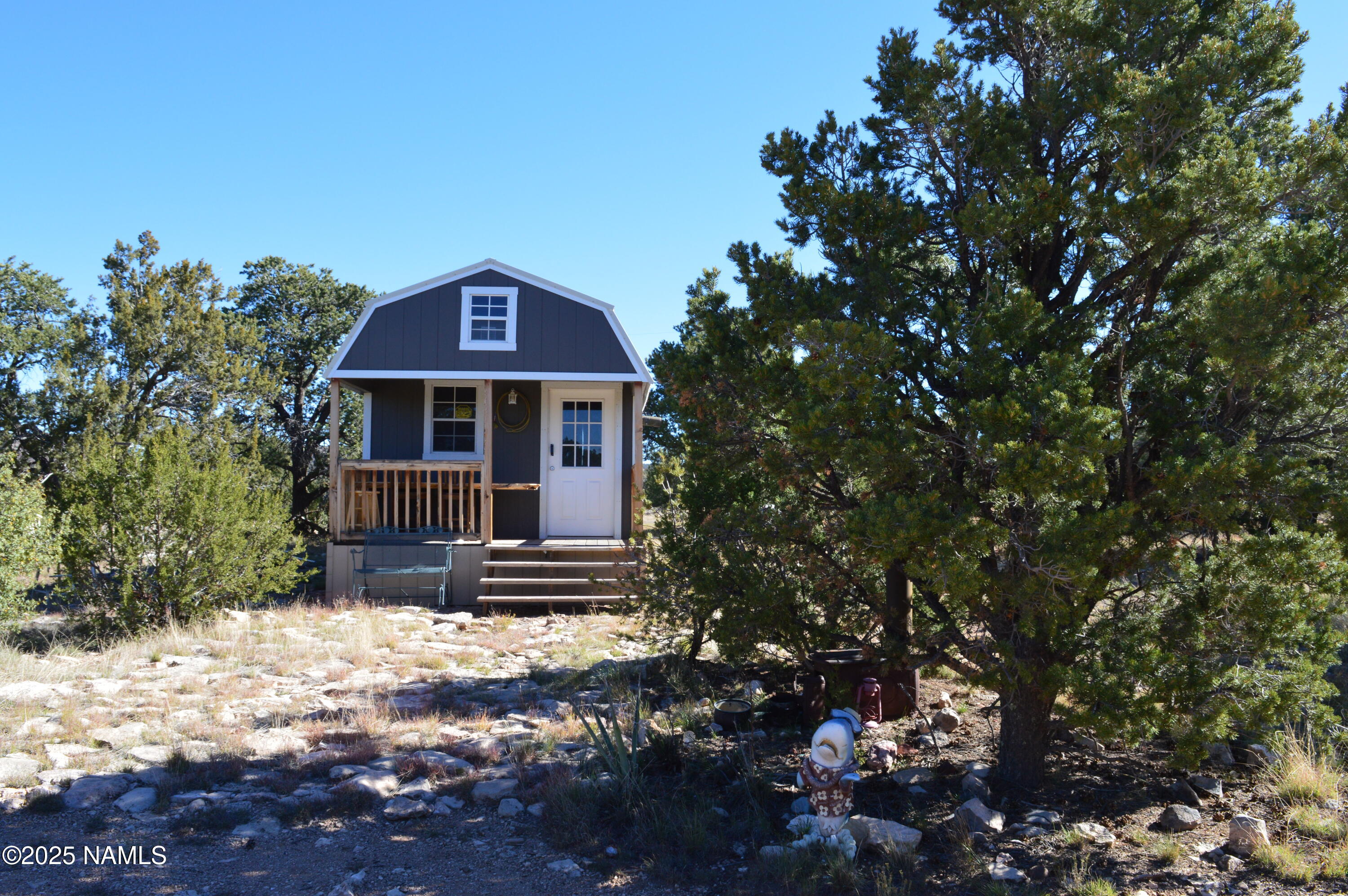 13887 Bly Station Road Williams, AZ 86046 - Photo 1 of 22 a front view of a house with yard and trees