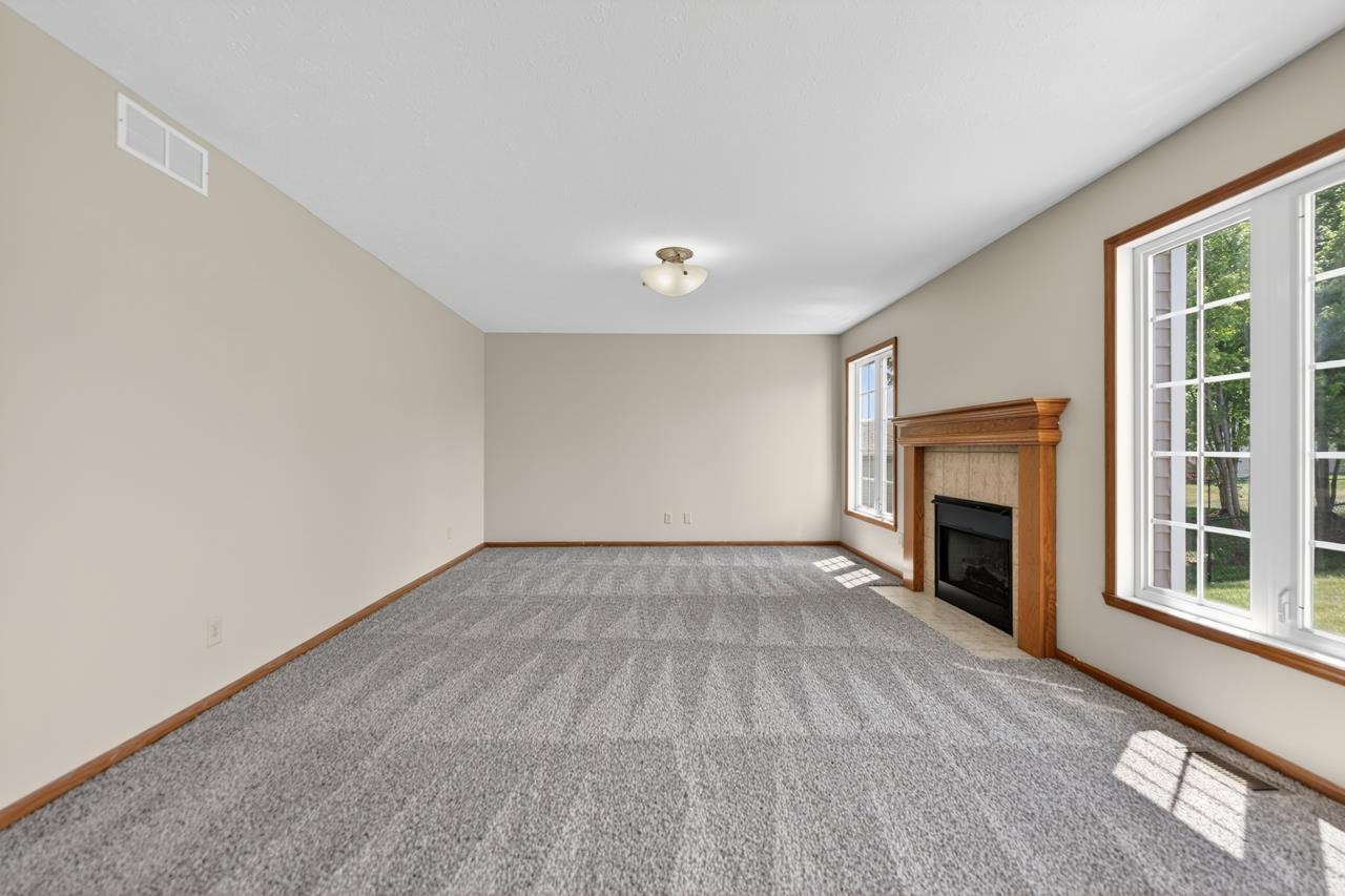 676 Elberon Way Roscoe, IL 61073 - Photo 8 of 30 wooden floor fireplace and windows in an empty room