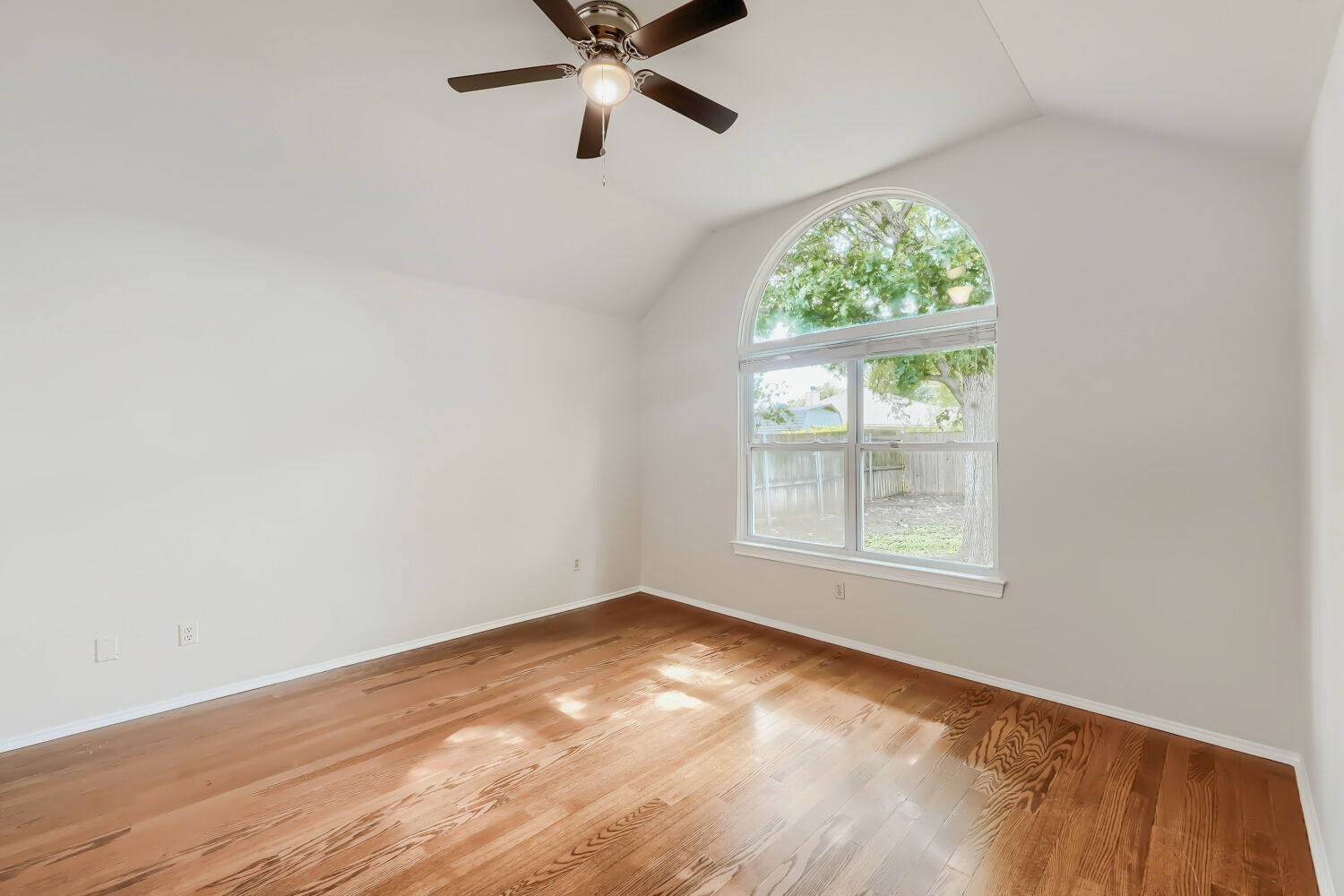 119 Stephen Lane Georgetown, TX 78626 - Photo 8 of 32 Vaulted ceiling, rich hardwood floors and a striking arched window enhance this peaceful bedroom space overlooking your private backyard.
