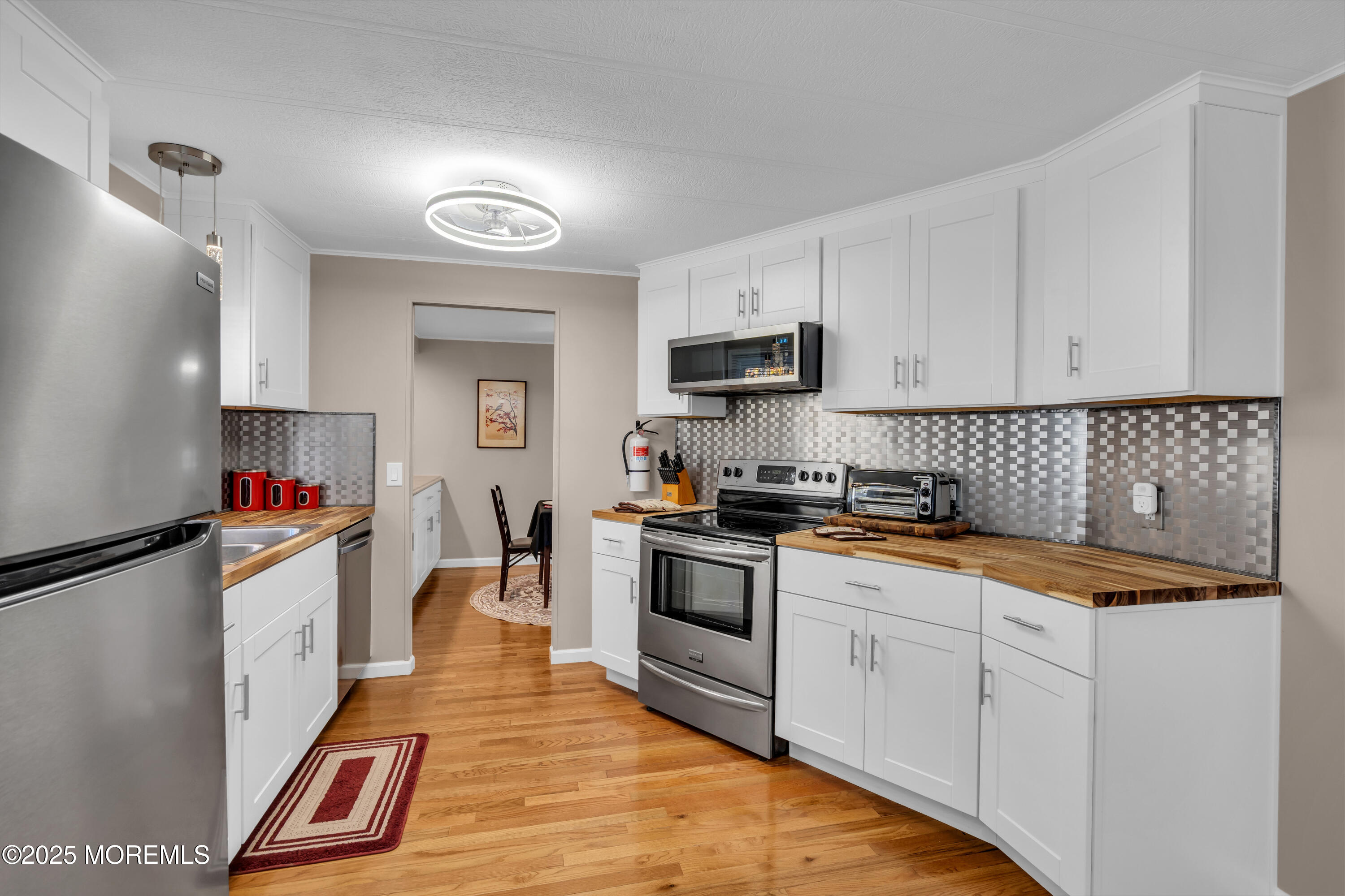 166 Mockingbird Way Whiting, NJ 08759 - Photo 12 of 28 a kitchen with granite countertop a stove and cabinets