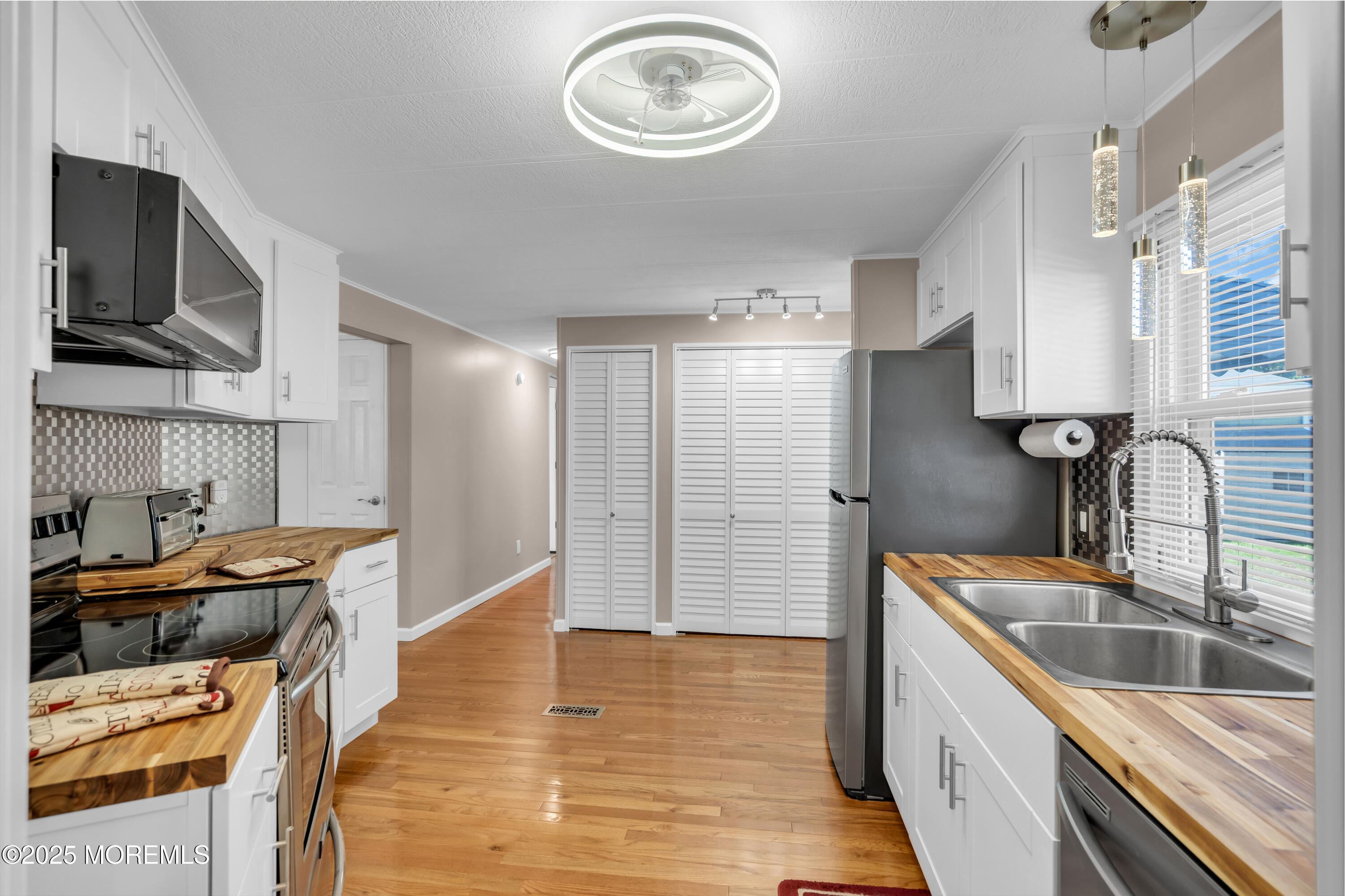 166 Mockingbird Way Whiting, NJ 08759 - Photo 13 of 28 a kitchen with stainless steel appliances granite countertop a sink stove and refrigerator