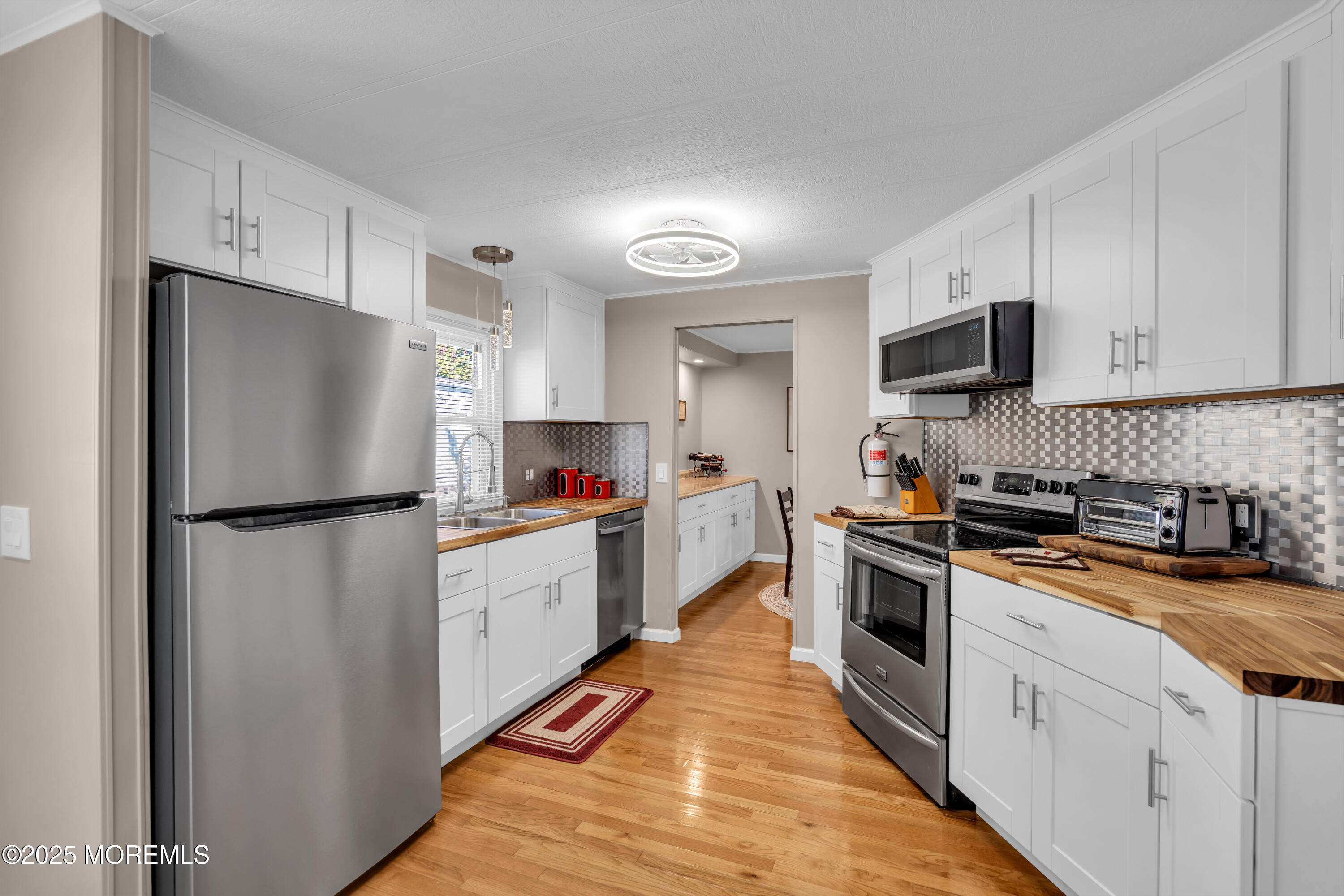 166 Mockingbird Way Whiting, NJ 08759 - Photo 14 of 28 a kitchen with white cabinets and stainless steel appliances