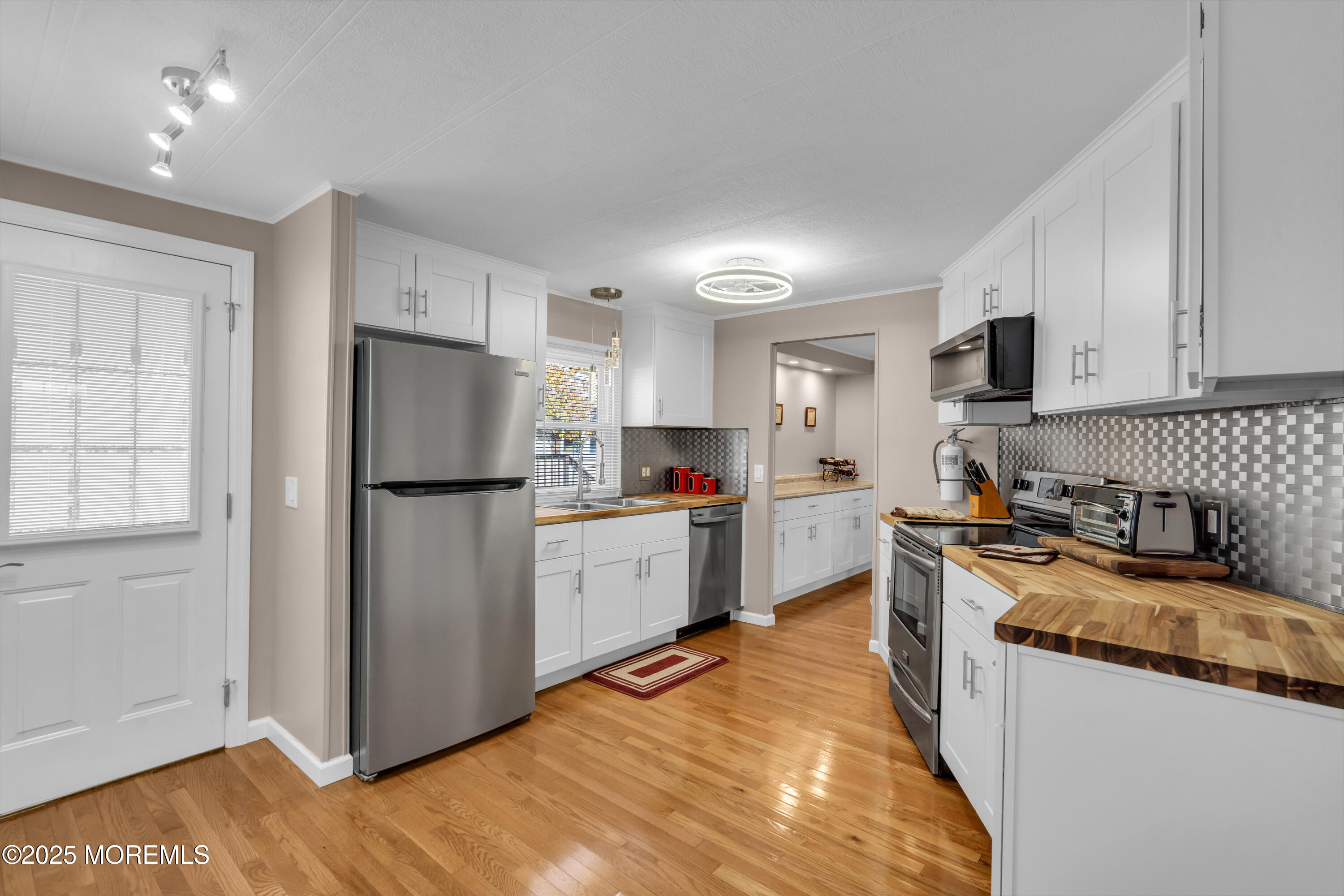 166 Mockingbird Way Whiting, NJ 08759 - Photo 15 of 28 a kitchen with a refrigerator a stove top oven a sink and dishwasher