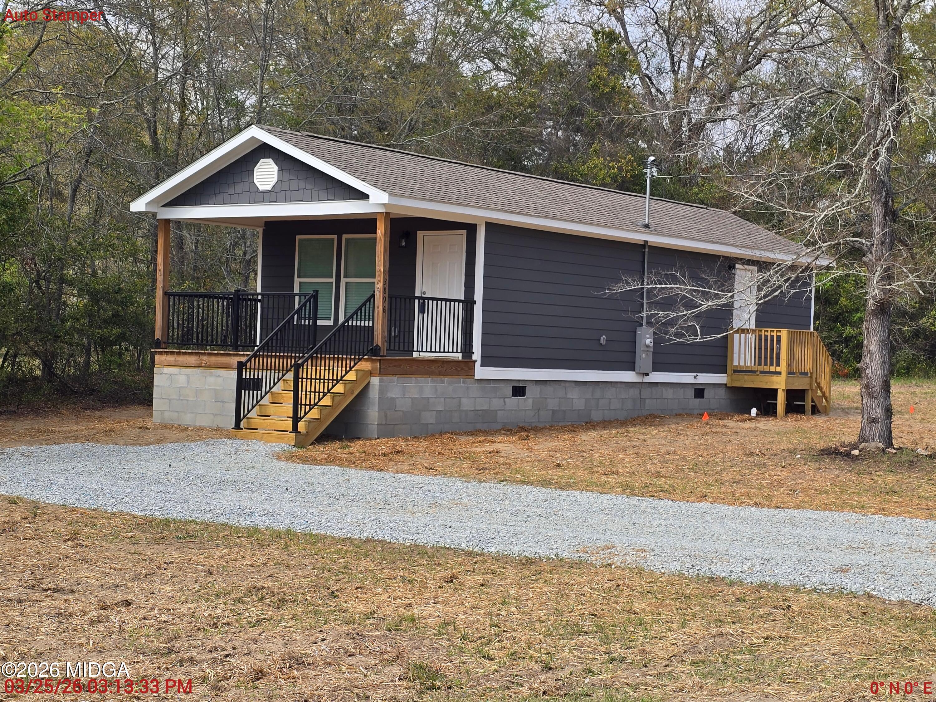 3896 Davis Road Macon, GA 31217 - Photo 2 of 12 a front view of a house with a yard and seating space