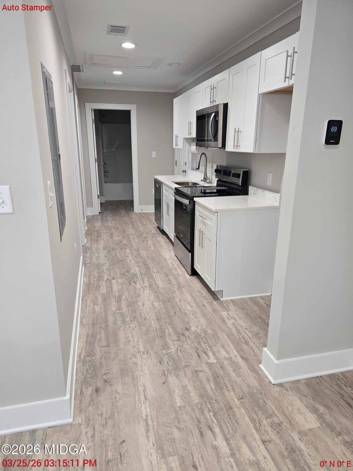 3896 Davis Road Macon, GA 31217 - Photo 4 of 12 a kitchen with granite countertop a refrigerator stove top oven and sink