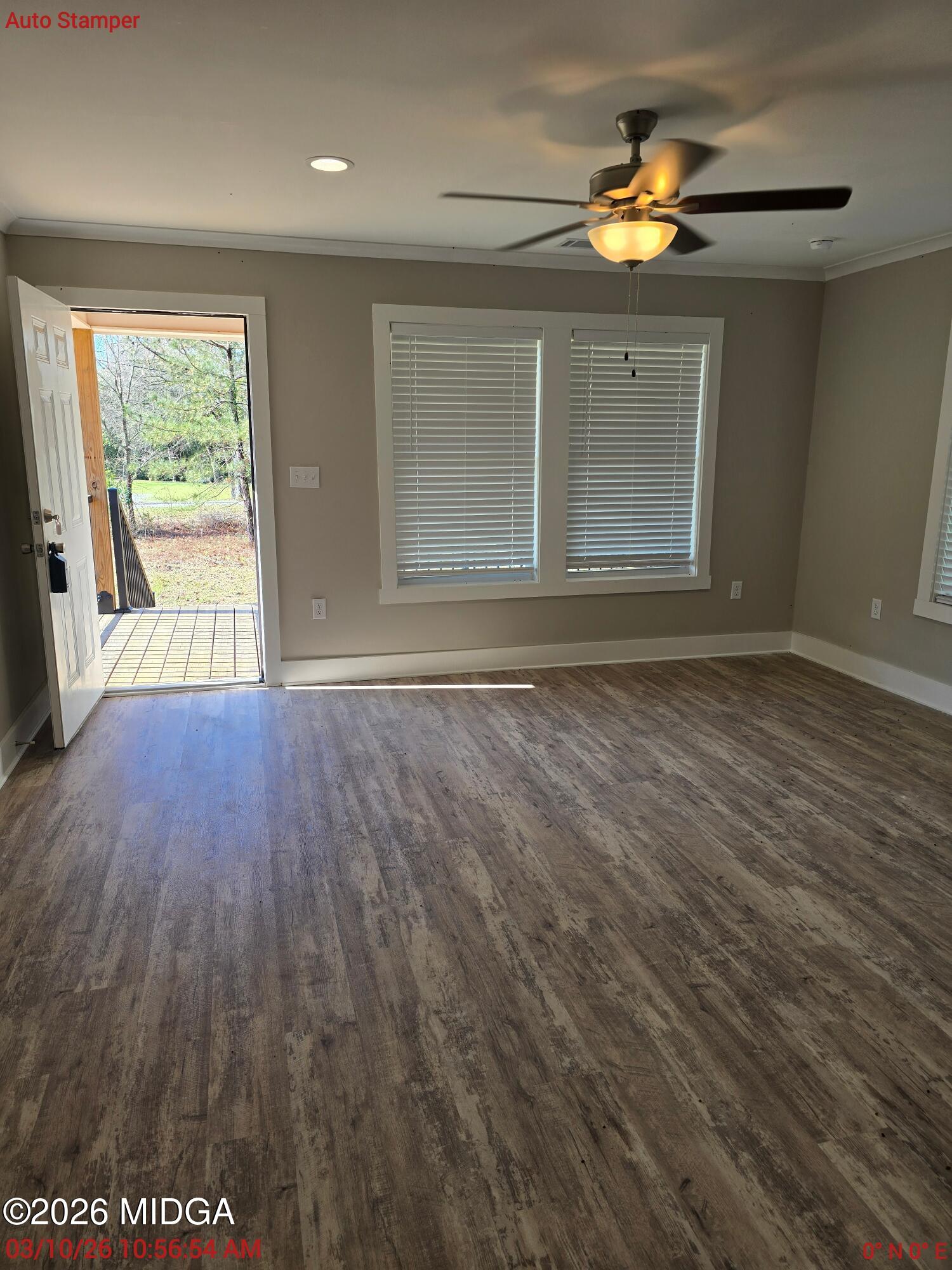 3896 Davis Road Macon, GA 31217 - Photo 5 of 12 a view of an empty room with a window and wooden floor