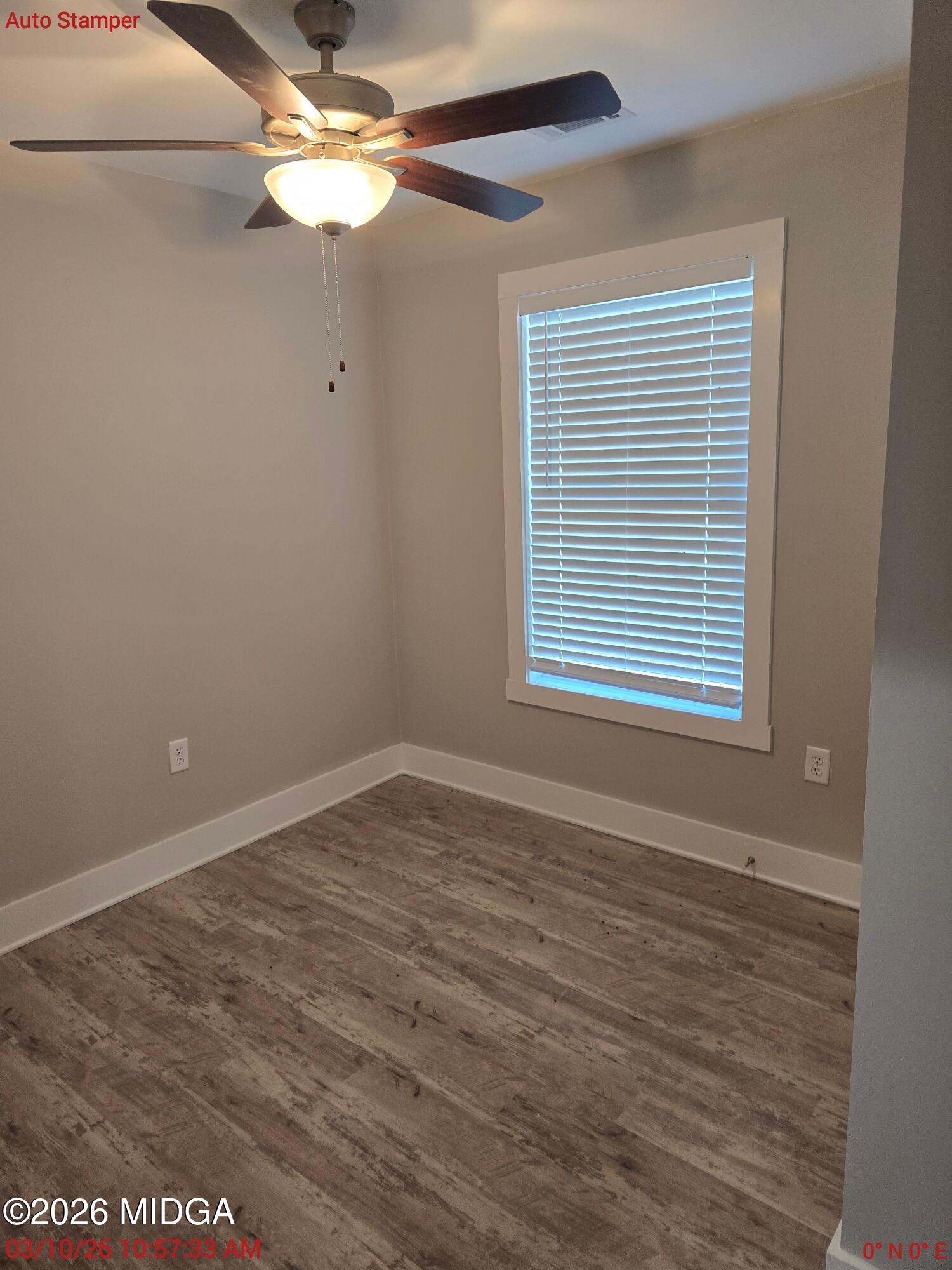 3896 Davis Road Macon, GA 31217 - Photo 7 of 12 a view of an empty room with wooden floor and a window