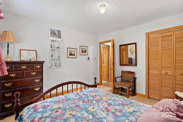 a bedroom with a bed a desk and chair