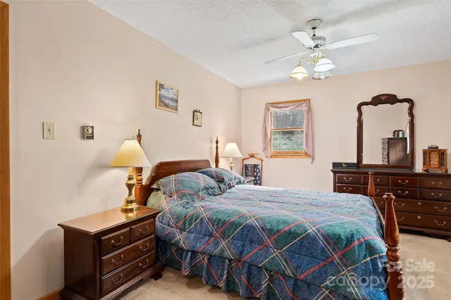 a bedroom with a bed and dresser with mirror