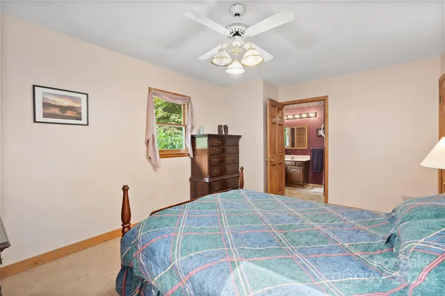 a bedroom with a large bed and a chandelier