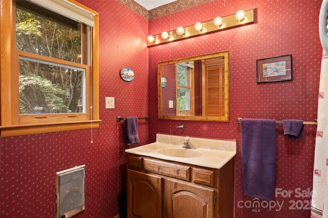 a bathroom with a sink a mirror and a window