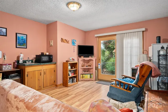 a bedroom with furniture and a flat screen tv