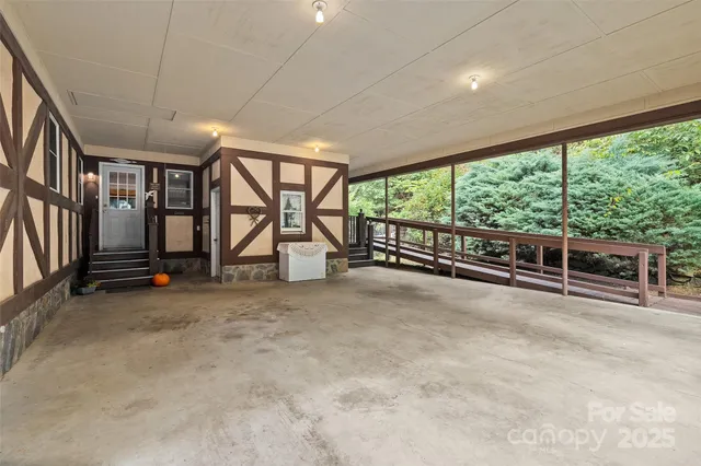 wooden floor chandelier and windows in an empty room