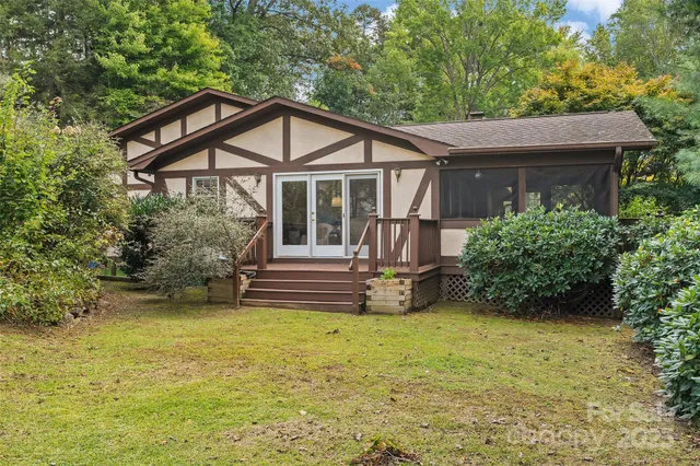 a view of a house with a yard and sitting area