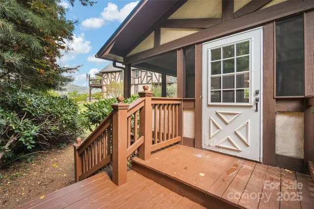 a view of a porch with wooden floor and floor to ceiling window and wooden floor