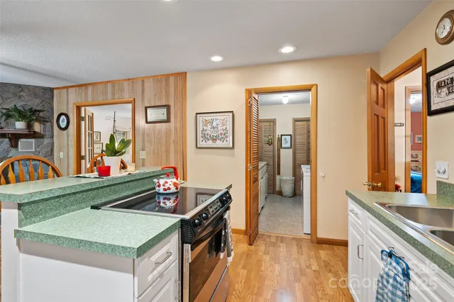 a kitchen with stainless steel appliances granite countertop a sink stove and cabinets