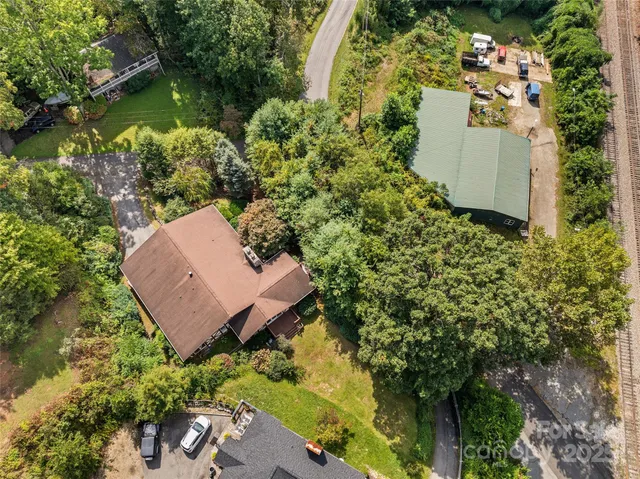 an aerial view of a house with a yard and lake view