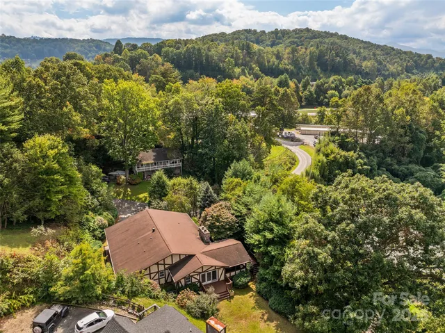 an aerial view of a house with a yard