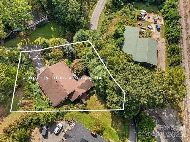 an aerial view of a house with a garden and swimming pool