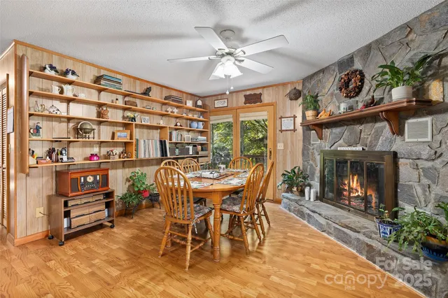 a dining room with furniture a fireplace and a chandelier