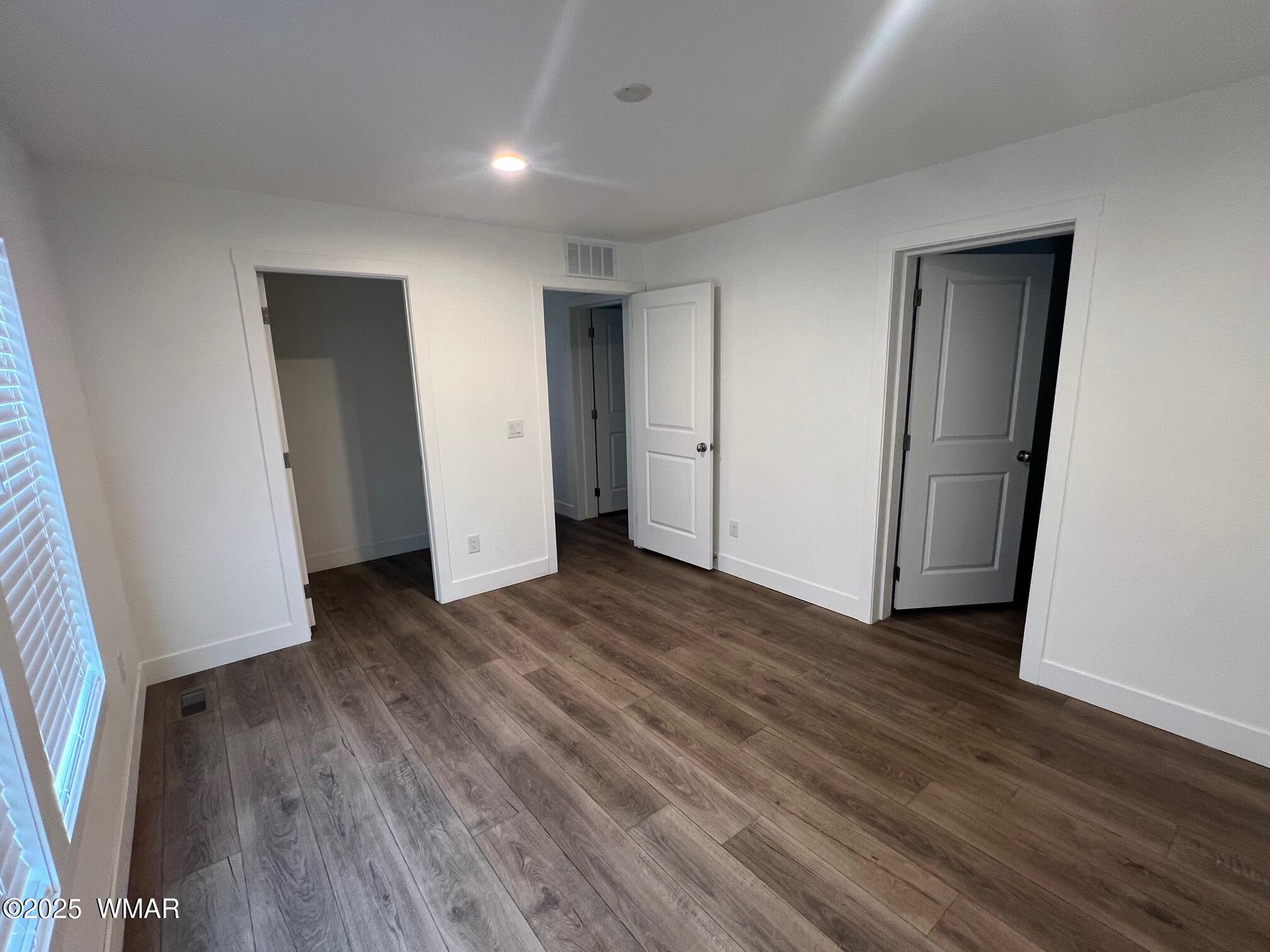 4129 Apache Road Snowflake, AZ 85937 - Photo 21 of 48 an empty room with wooden floor and closet