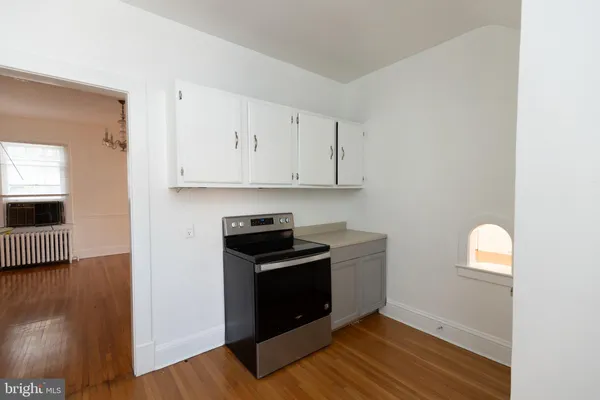 a kitchen with granite countertop a stove and a refrigerator
