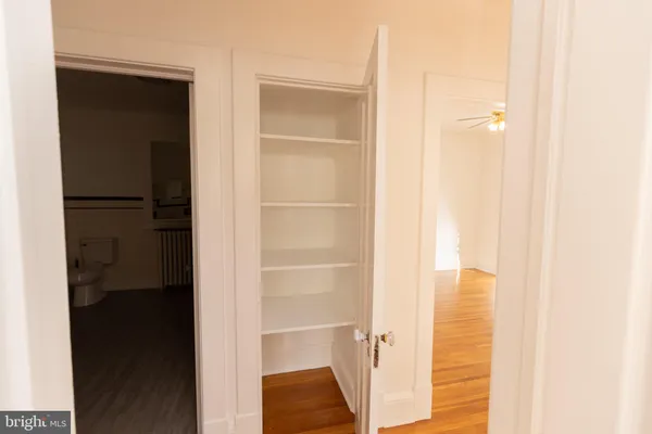 a bathroom with a glass shower door and a window