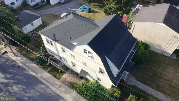 an aerial view of a house with a yard