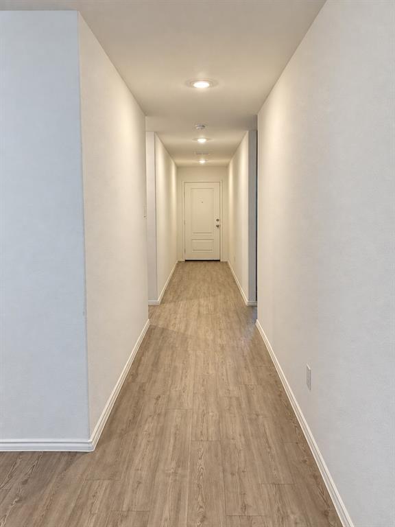 11726 Bone Spg Drive Rhome, TX 76078 - Photo 5 of 29 Bright, welcoming entry hallway featuring luxury vinyl plank flooring, recessed lighting, and neutral finishes that create a clean, cohesive look