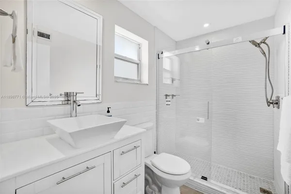 a bathroom with a sink toilet and shower