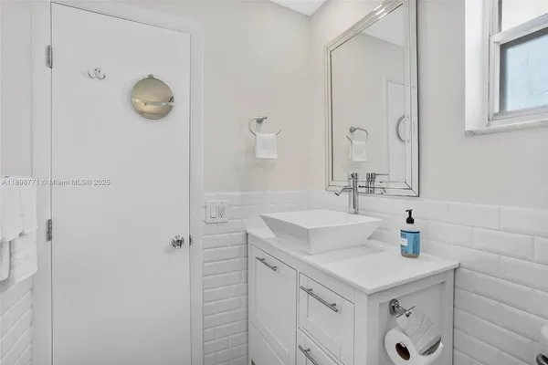a bathroom with a sink vanity and a mirror