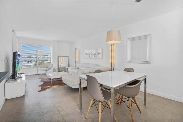 a view of a dining room with furniture and a window