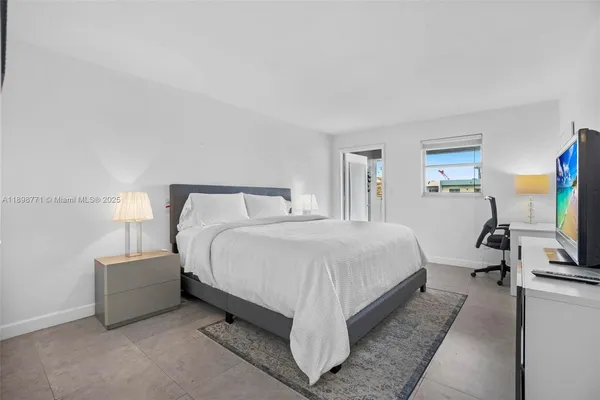 a bed room with a bed and a television