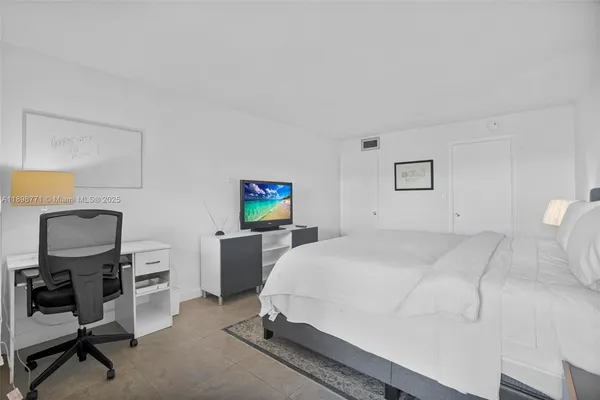 a bedroom with a bed and a desk