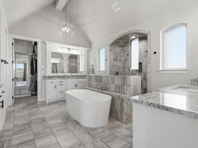 a large bathroom with a tub a sink and mirror