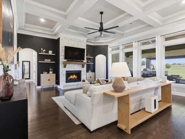 a living room with fireplace furniture and a flat screen tv