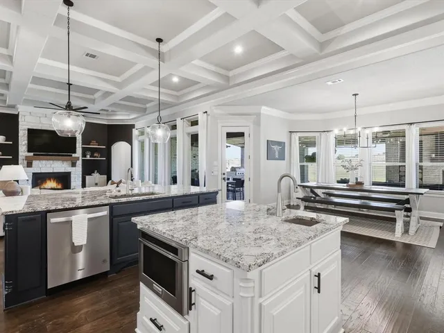 a kitchen with stainless steel appliances granite countertop stove top oven and cabinets
