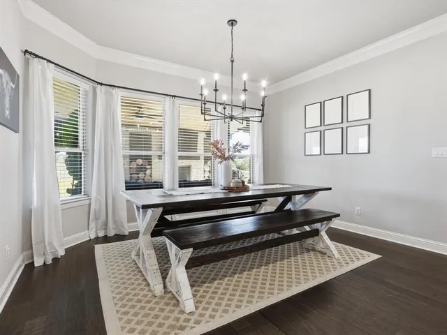 a living room with wooden floor and window
