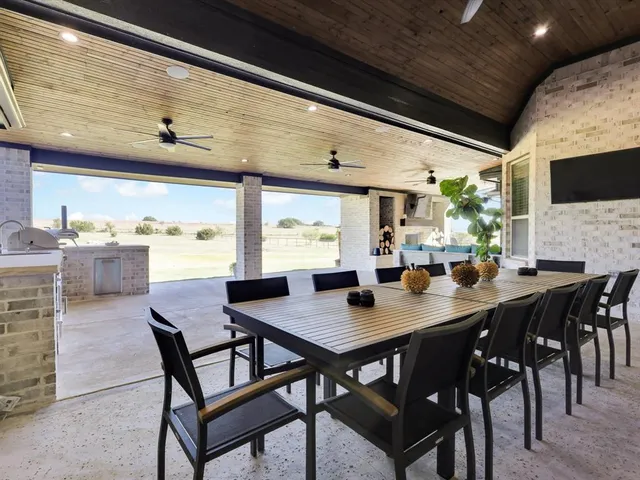 a large kitchen with stainless steel appliances granite countertop a stove a sink and dishwasher