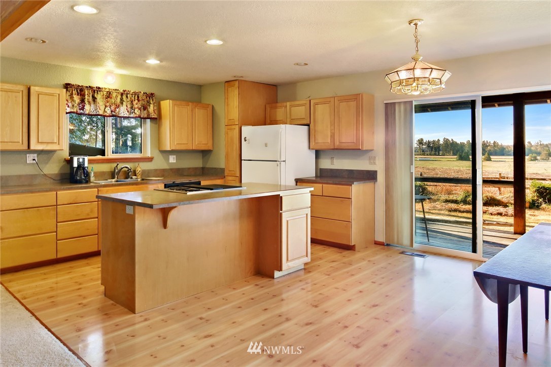 2587 Birch Bay Lynden Road Custer, WA 98240 - Photo 15 of 39 a kitchen with stainless steel appliances granite countertop a stove a sink a refrigerator and a granite counter tops with wooden floors