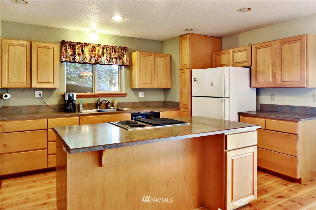 2587 Birch Bay Lynden Road Custer, WA 98240 - Photo 16 of 39 a kitchen with a refrigerator a stove a sink dishwasher and wooden cabinets