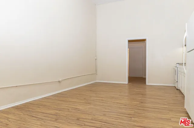 a view of a livingroom with wooden floor and a table