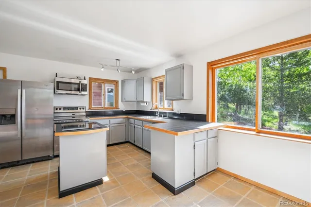 a kitchen with a sink stove and microwave