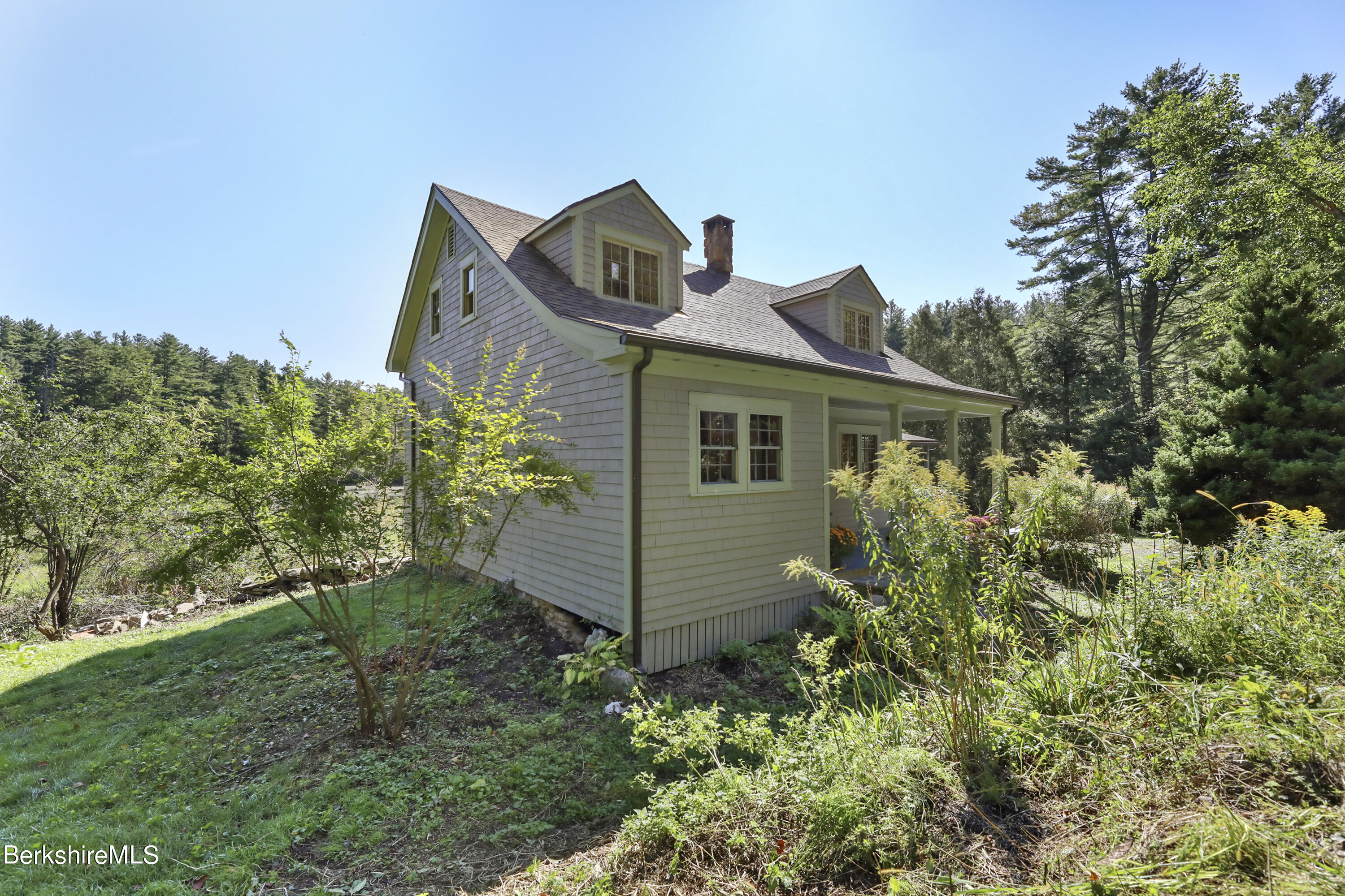 56 Brett Road Monterey, MA 01245 - Photo 3 of 22 a front view of a house with a yard and garage