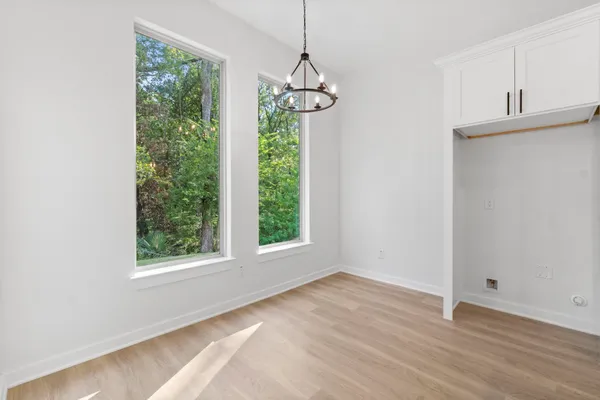 a view of a room with wooden floor and windows