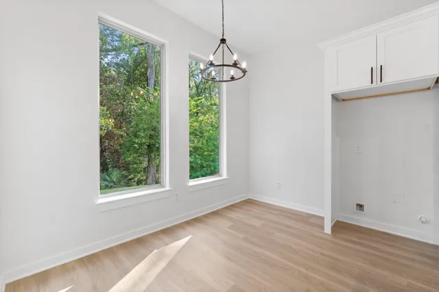 a view of a room with wooden floor and windows