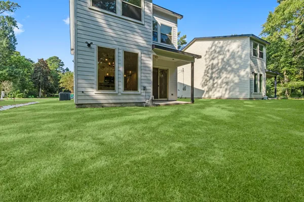 front view of a brick house with a yard