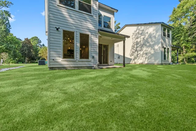 front view of a brick house with a yard