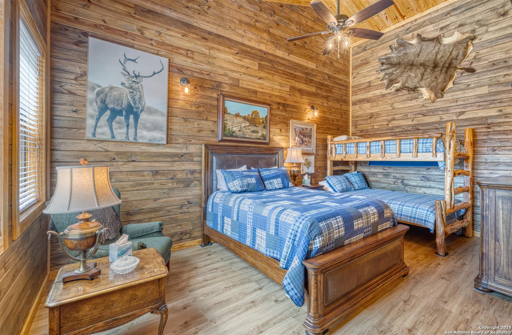 2242 Patterson Creek Road Leakey, TX 78873 - Photo 24 of 57 a bedroom with a bed and wooden floor